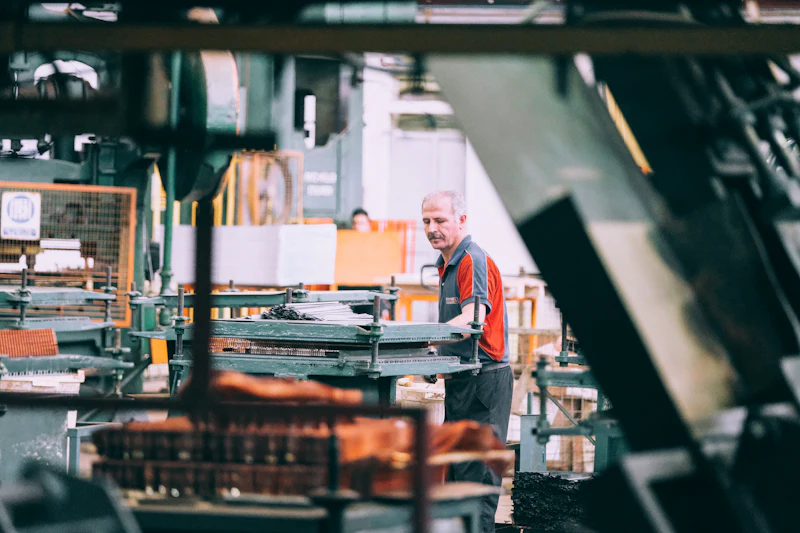 A technician operating industrial machinery in a factory